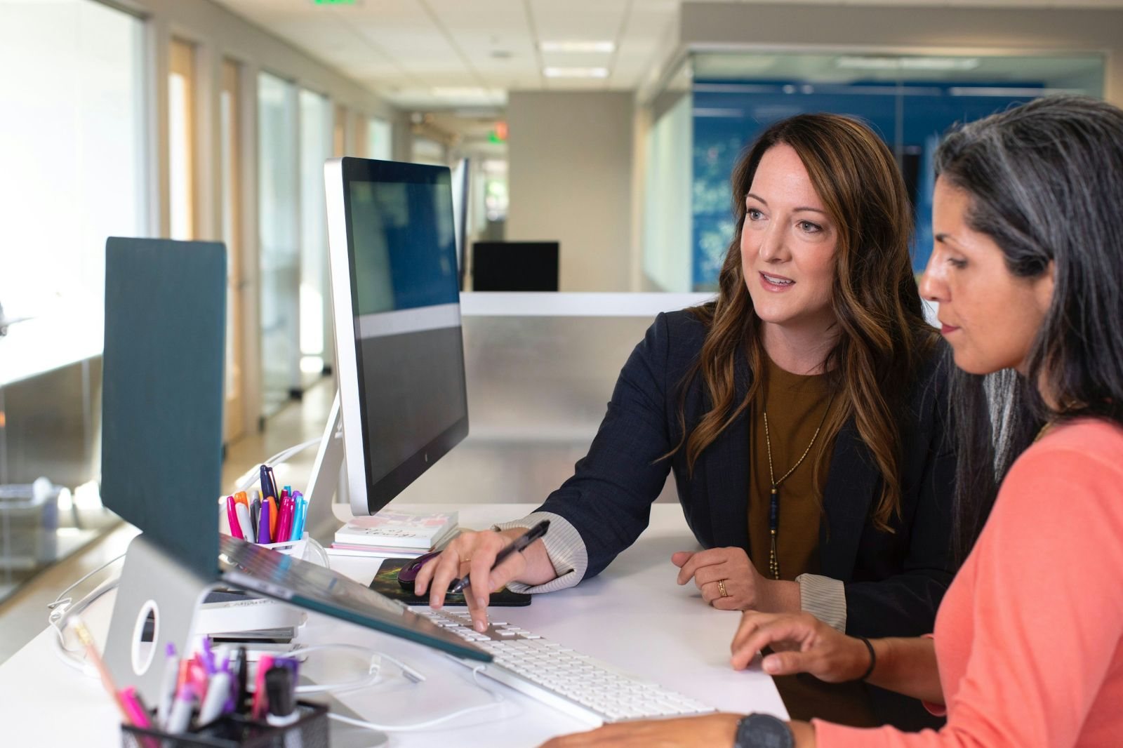 Financial advisor helping a client at her computer